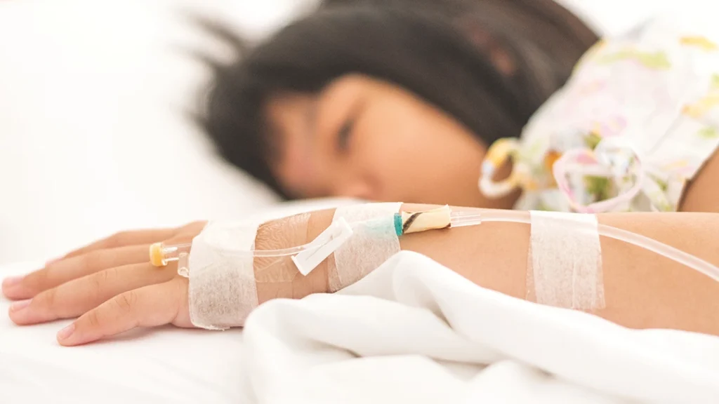 A little girl with a cannula in her hand