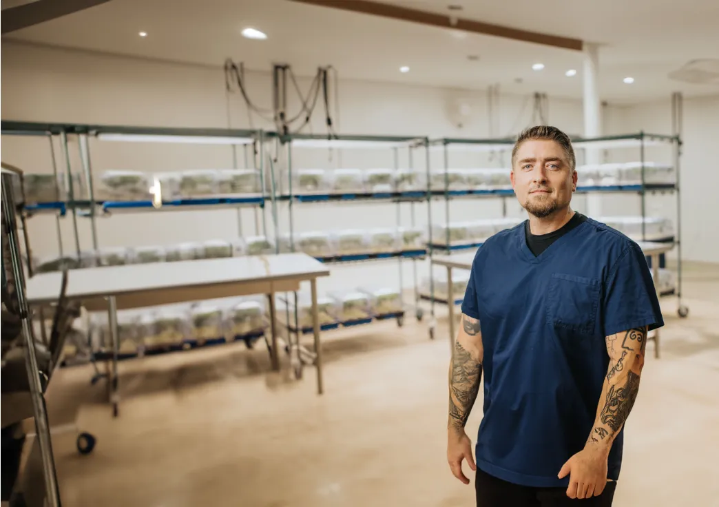 Young man with shelves in the background