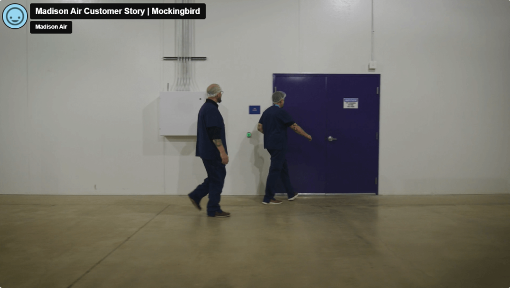 Two men walking to an office in a warehouse