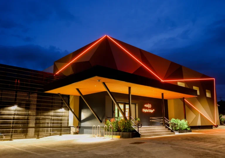 A modern building with a red-lit roof