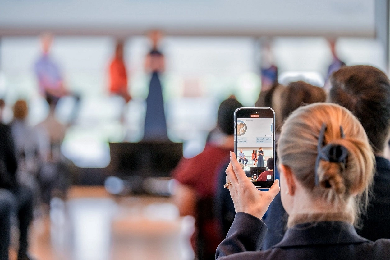 A woman taking a photo with a phone